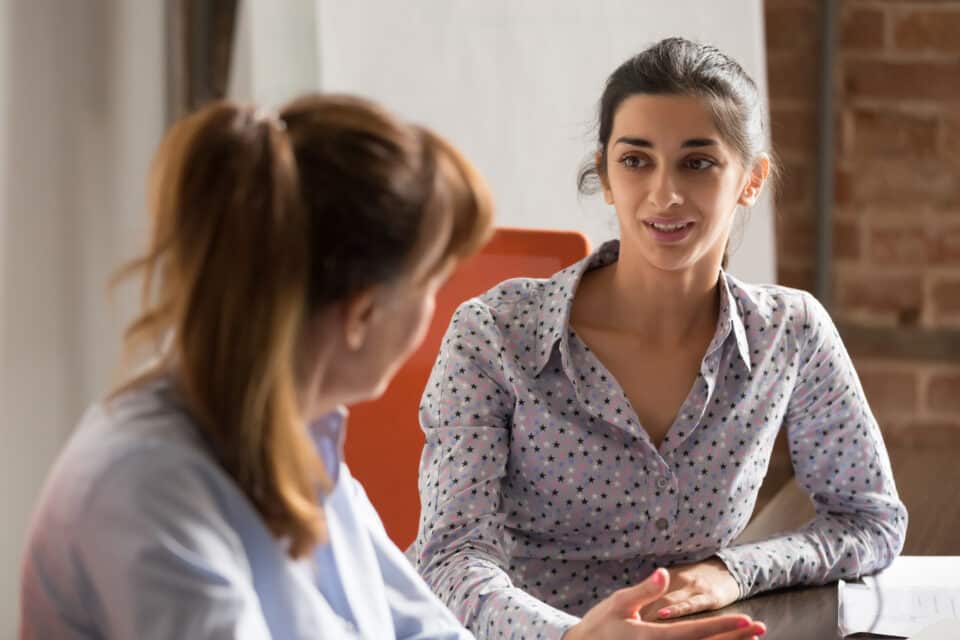 Two young women talking.