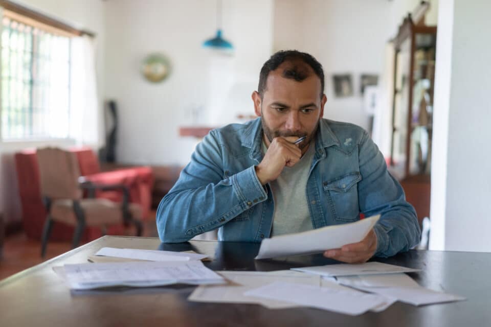 Latin American low income man checking his home finances