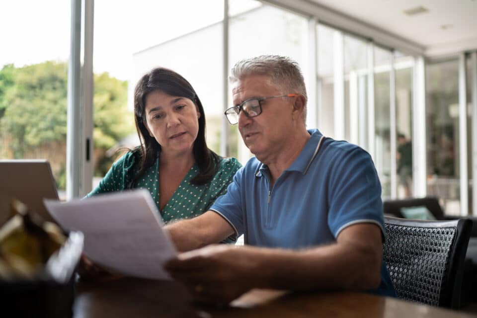 Man and woman reviewing the same paperwork together