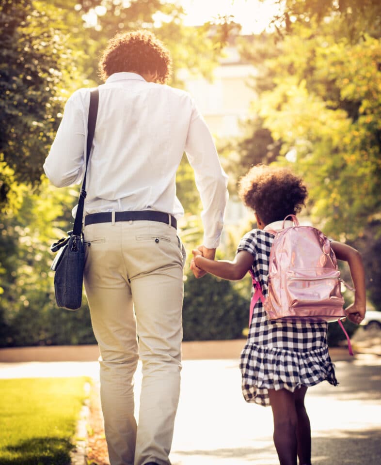 Father daughter walking to daughter's school.