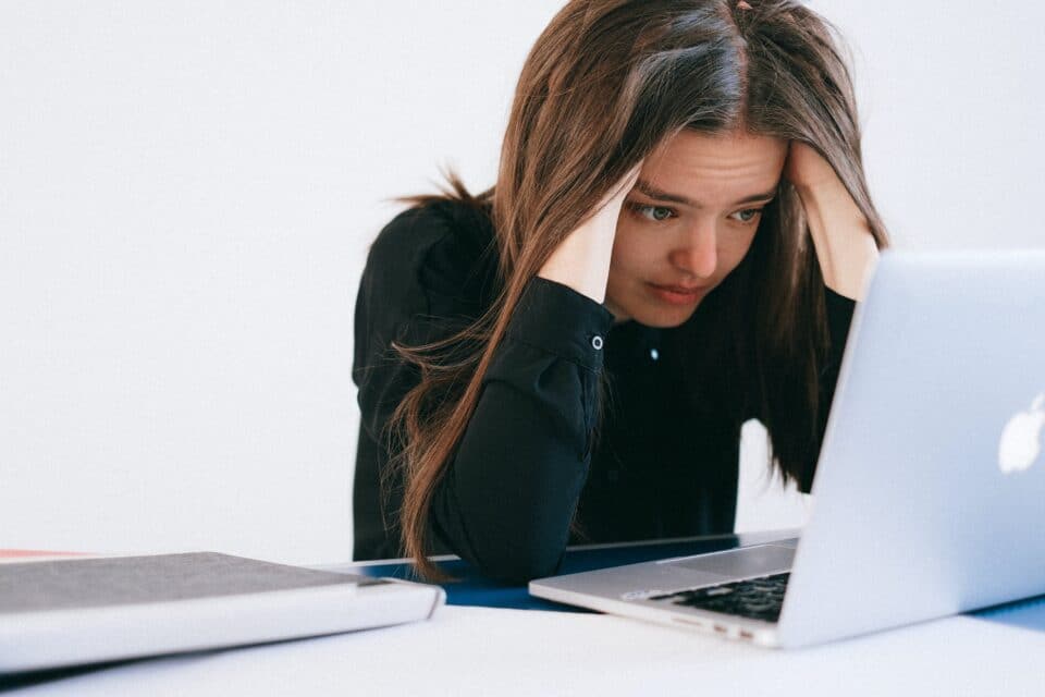 A woman stressed while considering an important choice.